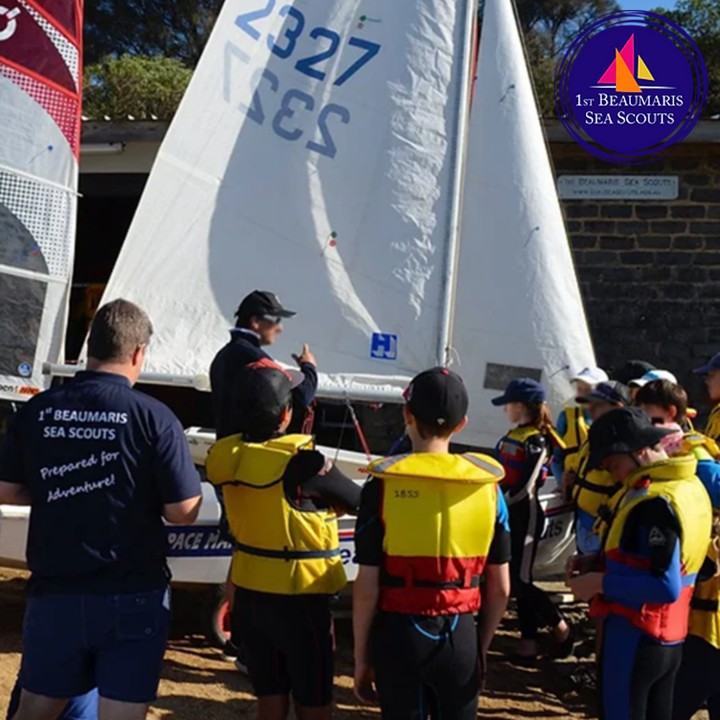 Kids with life vests near a sailboat