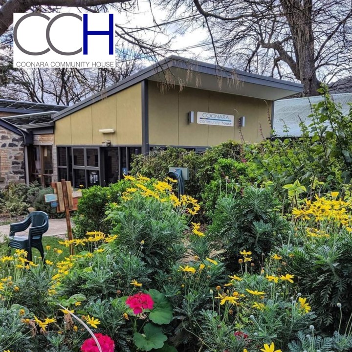 Lush garden with the community centre in the background