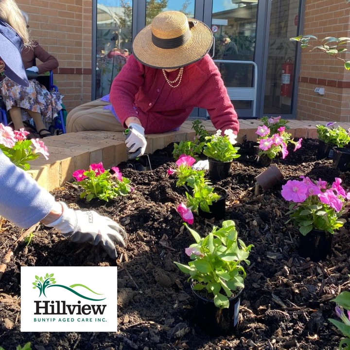 Lady with a large hat gardening 