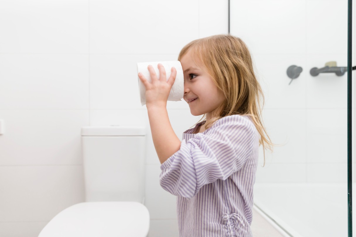 Girl looking through a toilet roll