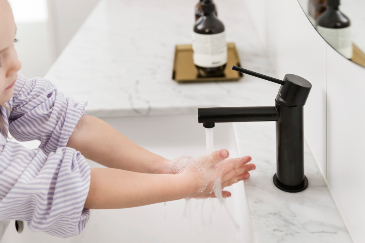 Girl customer washing hands in the bathroom