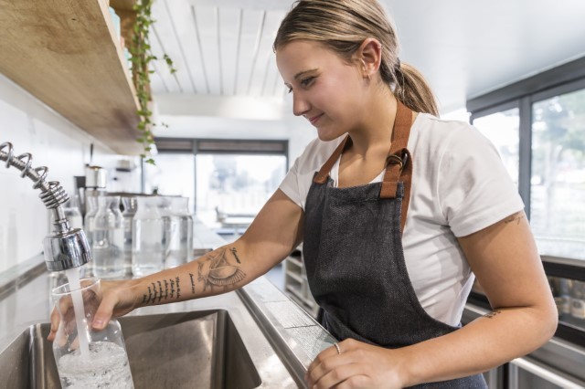 Filling a water jug at a cafe