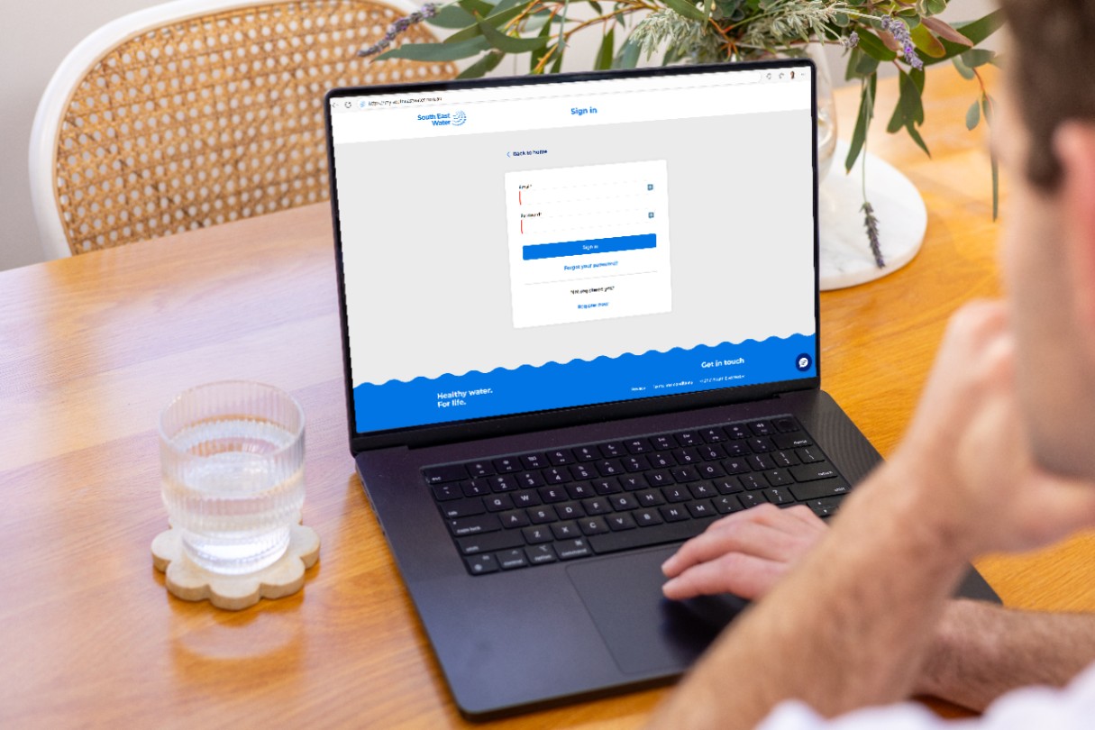 Person looking at a laptop screen with the mySouthEastWater log in page on the screen