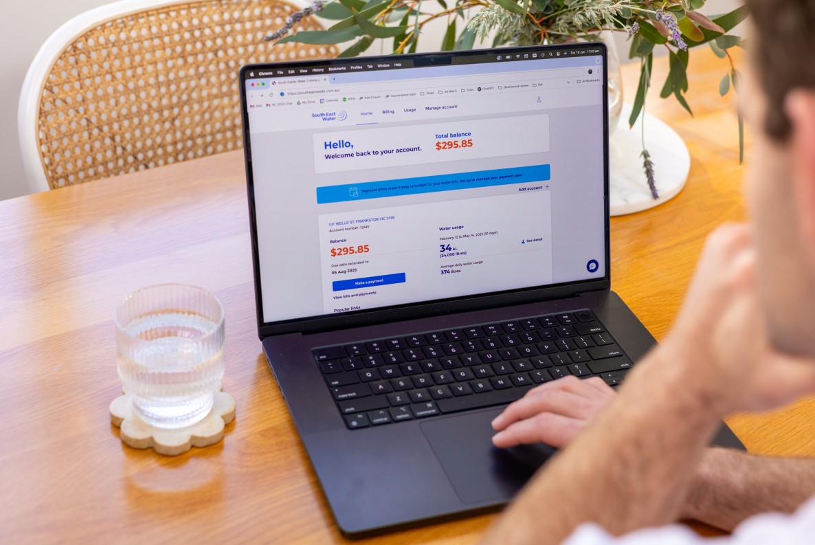 Open laptop with mySouthEastWater portal open and a blurred out person looking at it.